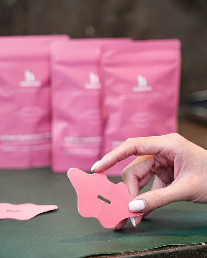 model holding mouth tape in bathroom